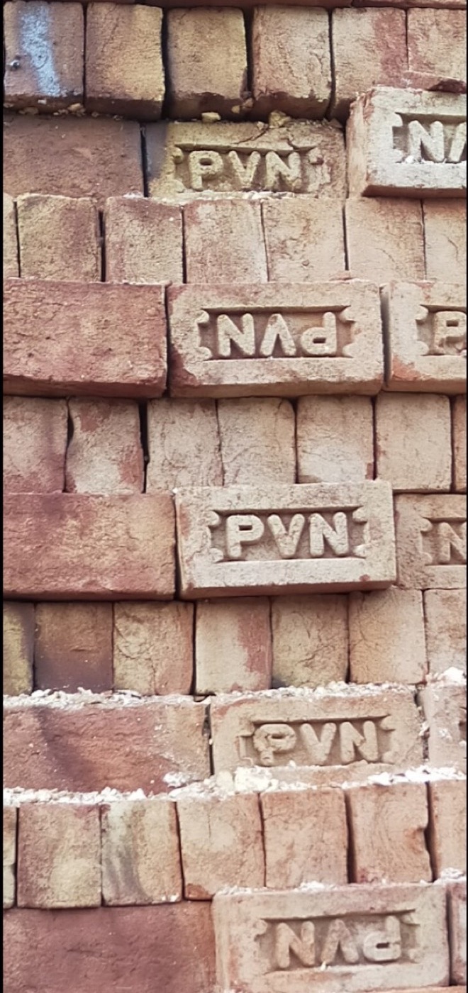 A wall of red bricks with the PVN stamp facing out