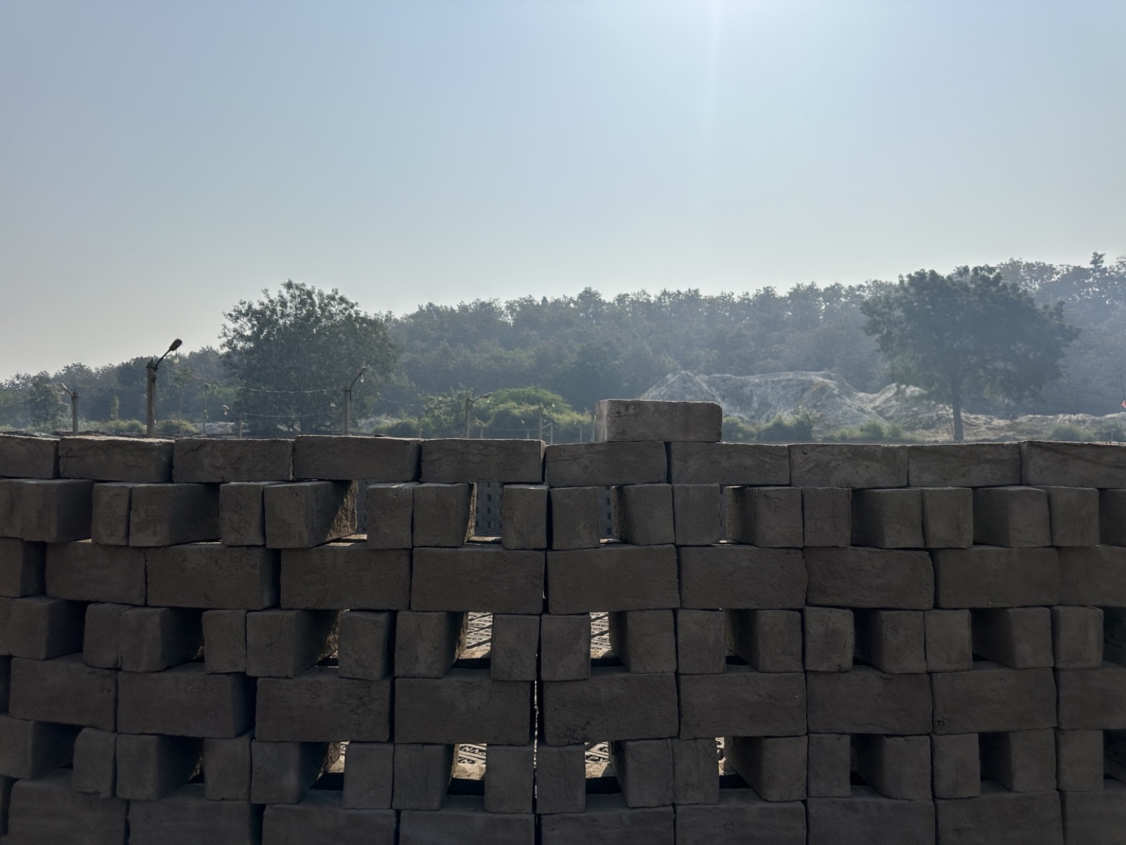 Raw bricks stacked in an open lattice before firing